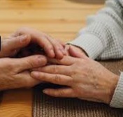 Hands held gently at a table